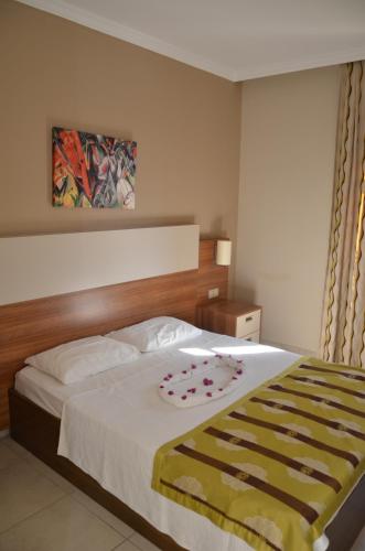 a bedroom with a large bed with a white bedspread at Melissa Moment Apart in Kemer