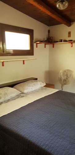 a bedroom with a large bed with a window at Appartamenti Villa Wanda in Palmi