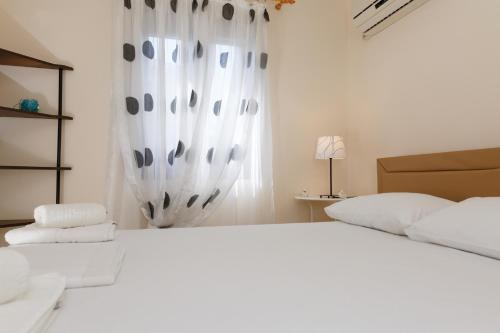 Ένα ή περισσότερα κρεβάτια σε δωμάτιο στο Glyfada Villas III