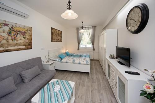 a living room with a couch and a bed at apartmán Marica in Luhačovice