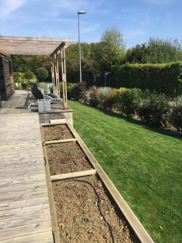 a garden with two raised beds in a yard at Chambres d'hotes ASAM in Lherm