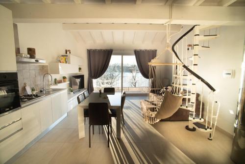 a kitchen with a table and a dining room at Lake House I Pioppi in Nepi