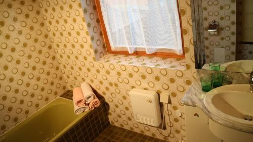 a bathroom with a sink and a toilet and a bath tub at Stadl Suite in Sankt Margarethen im Lavanttal