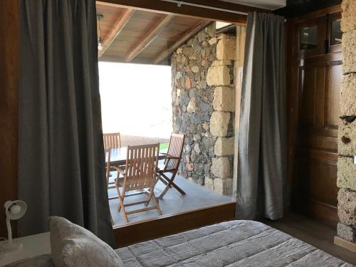 a bedroom with two chairs and a table on a balcony at Casa de Los Alberconcillos in Agüimes