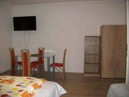 a room with a bed and a table and chairs at Éden II. in Miskolctapolca