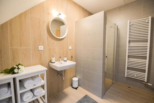 a bathroom with a sink and a shower at Chata VYPO in Liptovský Ján