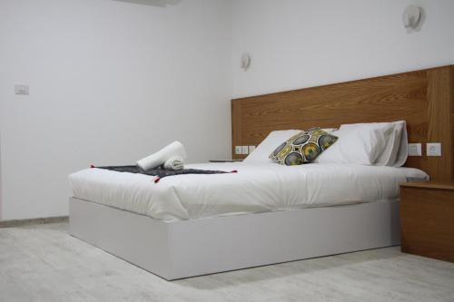 a white bed with a phone on top of it at LAMITA in Majdal Shams