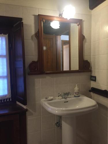a bathroom with a sink and a mirror at La Rondine sul Lago d'Orta in Arola
