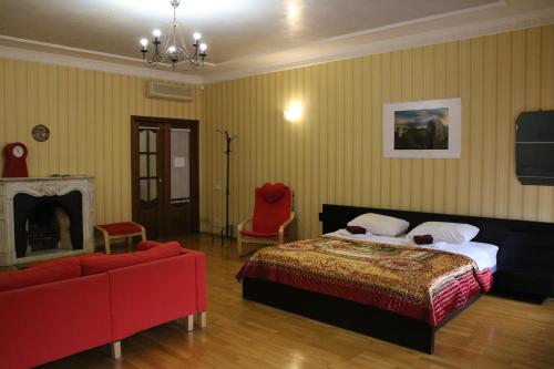 a bedroom with a bed and a couch and a fireplace at Apartment Nevskaya Classica in Saint Petersburg