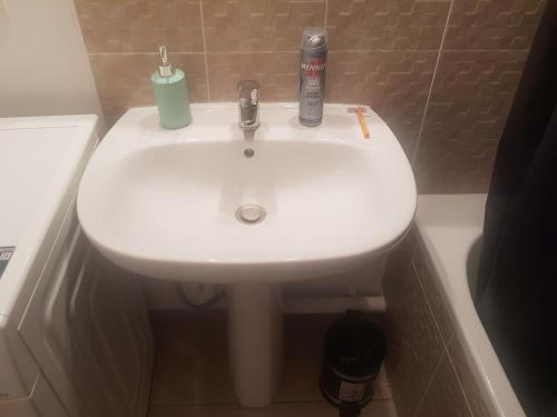 a bathroom with a white sink in a bath tub at Private room CDG airport Parc Expo in Villepinte