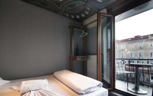 a room with a bed and a large window at Stay Inn Taksim Hostel in Istanbul