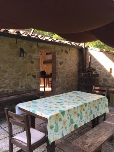 a table with a flowered table cloth on it at Agriturismo le Colline in Montescudaio