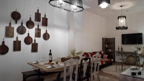 a dining room with a table with chairs and vases on the wall at República Guest House in Coimbra