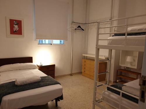 a bedroom with two bunk beds and a ladder at Apartamento Alfaqueque in Seville