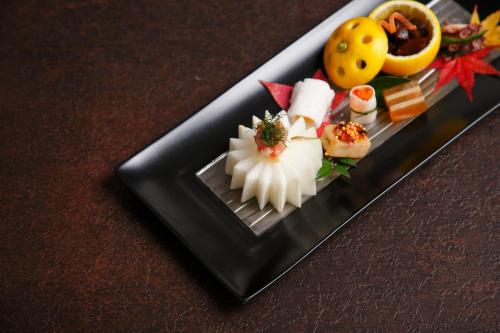 a plate of food with sushi on a table at AMANE resort SEIKAI in Beppu