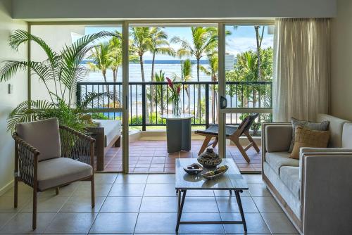 a living room with a couch and a table at Shangri-La Yanuca Island, Fiji in Voua