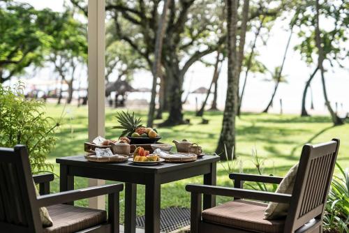 a table with a tray of food on a patio at Shangri-La Yanuca Island, Fiji in Voua