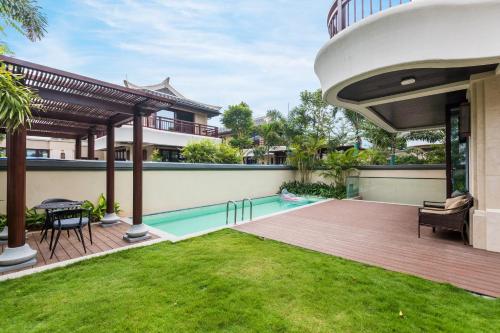 an image of a backyard with a swimming pool and a house at HaitangBay Loosen Coast Resort Villas in Sanya