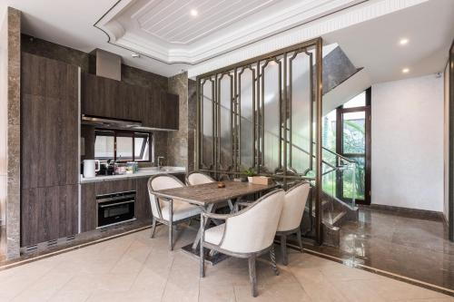 a dining room with a table and chairs at HaitangBay Loosen Coast Resort Villas in Sanya