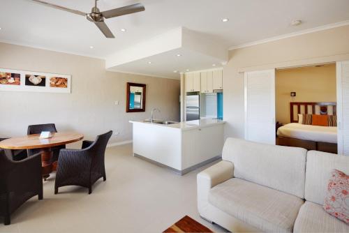 a living room with a couch and a table at Seashells Broome in Broome