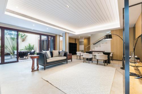 a living room with a couch and a table at HaitangBay Loosen Coast Resort Villas in Sanya