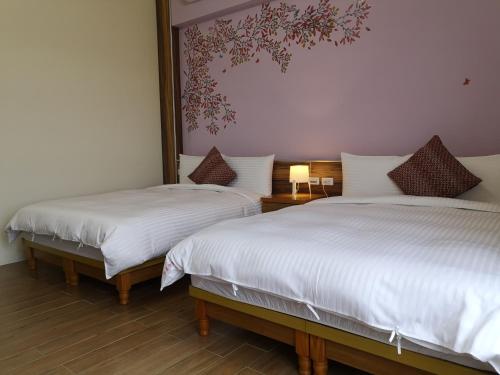 Postel nebo postele na pokoji v ubytování Hengchun Inn