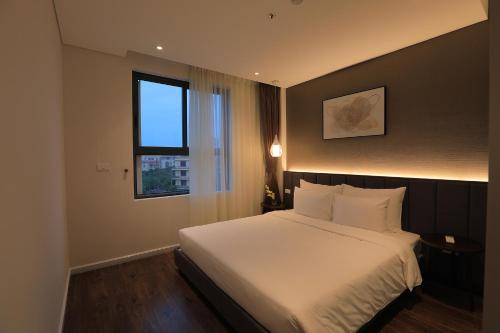 Postel nebo postele na pokoji v ubytování Mandala Hotel & Spa Bac Ninh