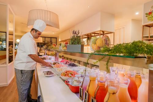 a chef preparing a buffet in a restaurant at Mercure Brisbane King George Square in Brisbane