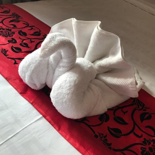 a pile of towels sitting on top of a bed at Golden Bakong Boutique in Siem Reap