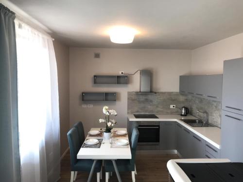 a kitchen with a table and chairs and a kitchen with a counter at "Country House il Brolo" in Polpenazze del Garda