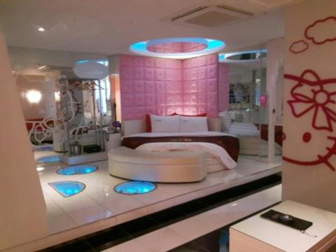 a bedroom with a large bed with blue lights at Esia hotel in Daegu