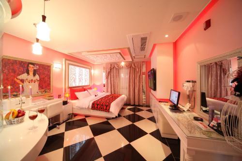 a bedroom with a bed and a checkerboard floor at Esia hotel in Daegu