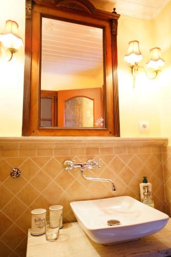 a bathroom with a sink and a mirror at Penzion Restaurant Jakub in Poprad