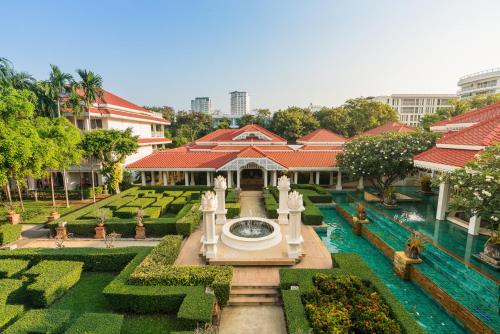 a building with a fountain in the middle of a garden at Wora Bura Hua Hin Resort & Spa in Hua Hin