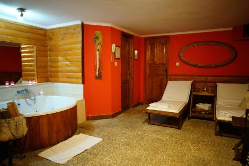 a bathroom with a tub and a sink at Penzion Restaurant Jakub in Poprad