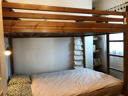 a bedroom with a bunk bed with a ladder at Aegean Sunset in Damouchari
