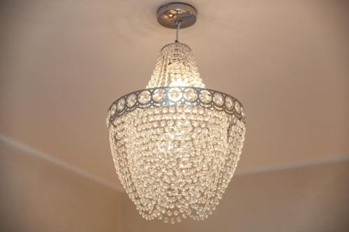 a silver chandelier hanging from a ceiling at Luxury Suite Sirmione in Sirmione
