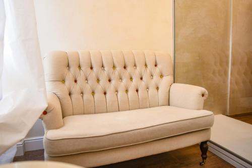 a white chair in a room with a curtain at Luxury Suite Sirmione in Sirmione