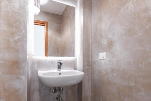 a bathroom with a sink and a mirror at Luxury Suite Sirmione in Sirmione