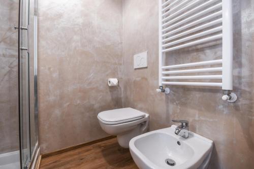 a bathroom with a toilet and a sink and a shower at Luxury Suite Sirmione in Sirmione