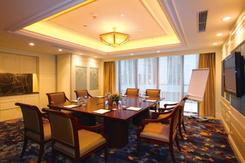 a conference room with a long table and chairs at Grand Central Hotel Shanghai - Nanjing Road in Shanghai