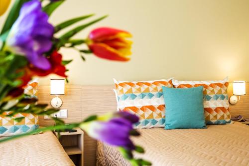 a bedroom with a bed with flowers on it at Geneva Hotel in Sofia