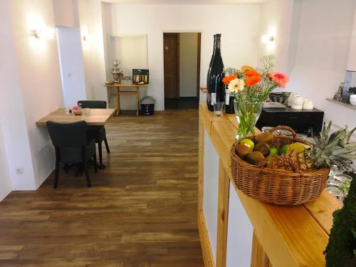 a room with a counter with a basket of fruit and wine bottles at Ferienresort Texas MV in Kirch Jesar