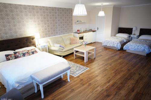 a bedroom with a bed and a couch and a living room at Apartments Casablanca in Poprad