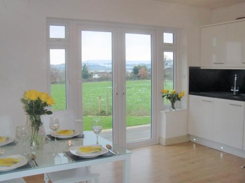 a kitchen with a table with plates of food on it at The Annex at Highmead in Exeter