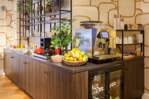 a counter with a bowl of fruit on it at The Delphi - Amsterdam Townhouse in Amsterdam