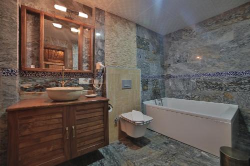 a bathroom with a tub and a sink and a toilet at Caravanserai Inn Hotel in Goreme