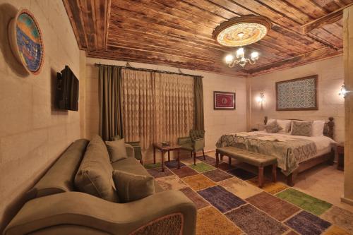 a living room with a couch and a bed at Caravanserai Inn Hotel in Goreme