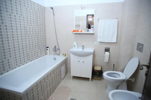 a bathroom with a tub and a toilet and a sink at RCC2 in Focşani