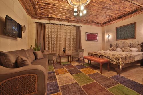 a living room with a bed and a couch at Caravanserai Inn Hotel in Goreme